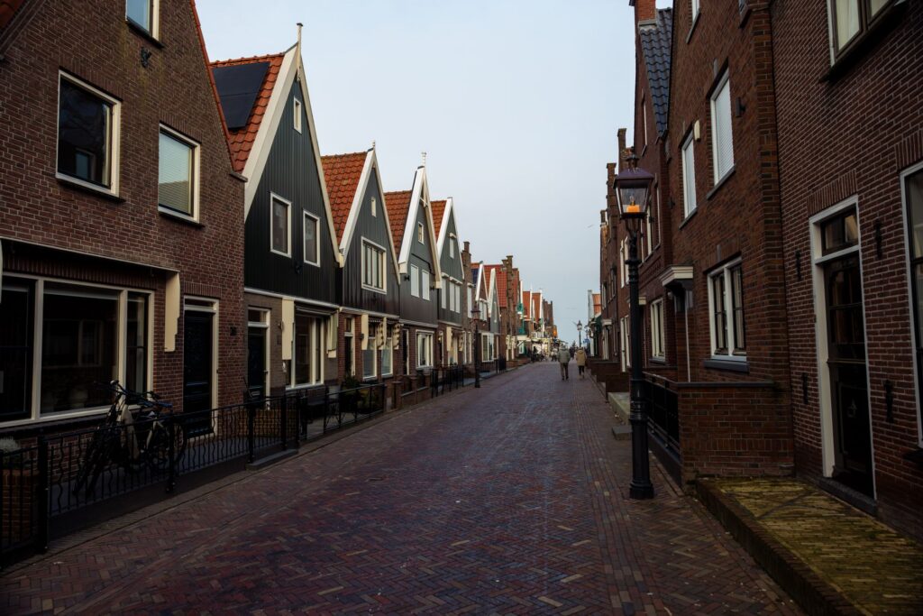 Straat met bakstenen huizen en puntgevels in een Hollands dorp
